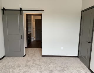 Bedroom looking into pass through closet and connected bathroom