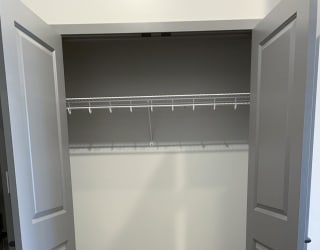 Empty hall closet with bifold doors