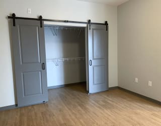 Large walk in closet with sliding barn doors on the outside