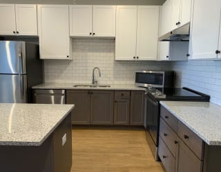 Luxury kitchen with matching stainless steel appliances and large granite counters at Haven at Uptown in Lincoln, Nebraska