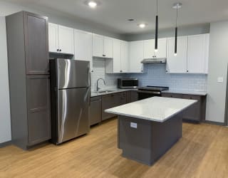 Luxury kitchen with matching stainless steel appliances and large granite counters at Haven at Uptown in Lincoln, Nebraska