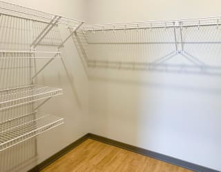 large walk in closet with rods and shelving for storage and hanging space