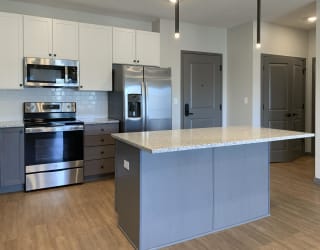 Kitchen with matching stainless steel appliances and large kitchen island