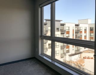 Master bedroom with large floor-to-ceiling window at Haven at uptown