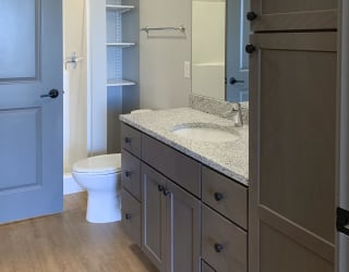 Large bathroom with standing shower and storage shelves at Haven at Uptown