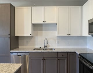 Multicolored cabinets in a kitchen at Haven at Uptown