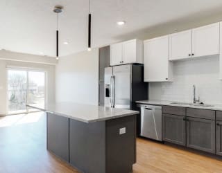Open concept kitchen and living space in the Bliss floor plan at Haven at Uptown in Lincoln, NE
