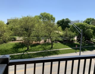 Scenic tree filled park view from outdoor balcony at Haven at Uptown in Lincoln.