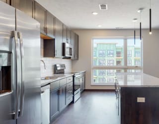 Spacious kitchen with mocha finishes in the Melody floor plan at Haven at Uptown in Lincoln, NE