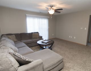 a living room with a couch and a ceiling fan