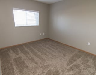a room with carpet and a window