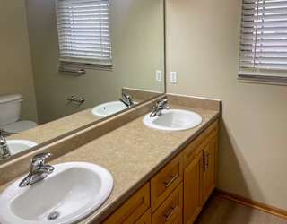 a bathroom with two sinks and a large mirror