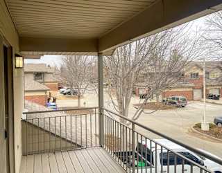 a view from a balcony overlooking a parking lot and other villas