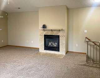 a living room with a fireplace and a mantle