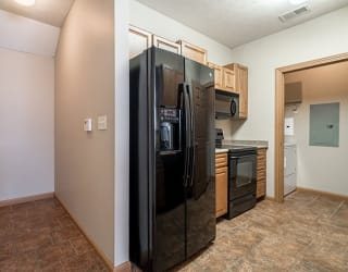 a kitchen with a refrigerator and a stove and a microwave