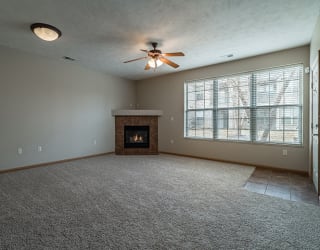 Spacious Large Living Room with Fireplace and abundant natural light at Stone Creek Villas Apartments in Omaha Nebraska