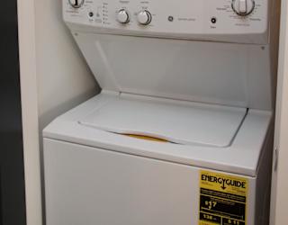 Stacked washer and dryer unit in a closet