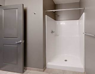 a bathroom with a walk in shower and a towel rack