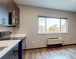 a kitchen and living room with a large window