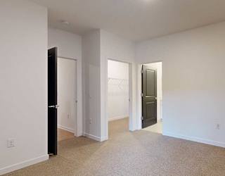 a large bedroom with an attached bath and walk in closet