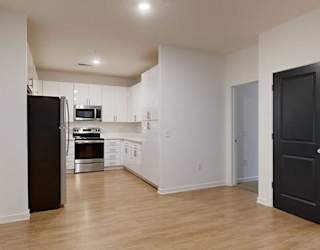 a modern kitchen with light cabinets and stainless steel appliances next to a dining area