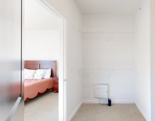 a bedroom with a bed and a toilet in a room