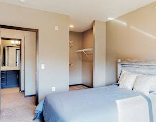 Furnished apartment bedroom with large walk in closet and easy bathroom access