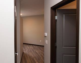 Entryway of studio apartment with bathroom door to the right