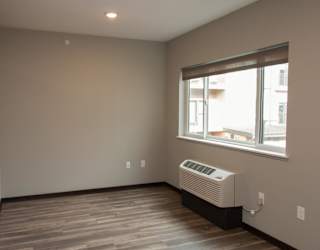 A room with a window and a wall hvac unit