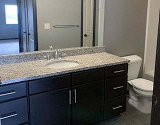 Spacious bathroom with tub shower and granite countertops in 1 bedroom apartment for rent at The Flats at 84 best apartments Lincoln NE 68516