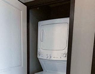 Full-size stacked washer and dryer included in in a 1 bedroom apartment for rent at The Flats at 84 apartments Lincoln NE 68516