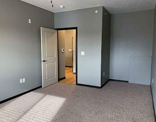 Large bedroom with ceiling fan and walk in closet in a 1 bedroom apartment for rent at The Flats at 84 best apartments Lincoln NE 68516