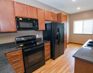 A kitchen with black appliances