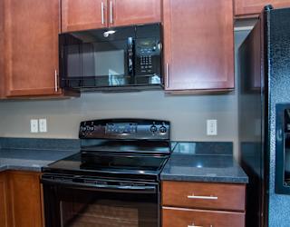 Black oven with a black microwave above it