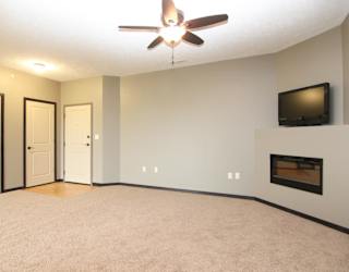 A living room with a fireplace and a television.