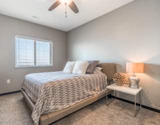 Living room with ceiling fan at The Flats at 84 in southeast Lincoln NE 68516