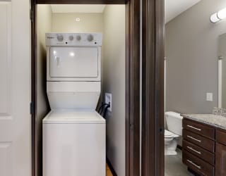 a stacked washer and dryer in a closet space