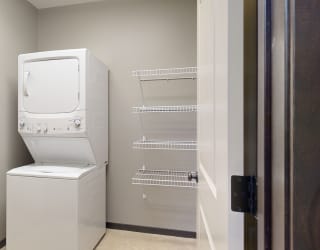 laundry room with a stacked washer and dryer