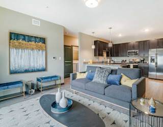 A modern living room with a grey sofa and a coffee table