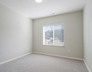 a bedroom with a large window