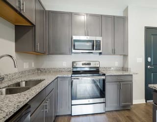 a kitchen with stainless steel appliances and granite counter tops