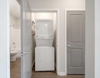 a stackable washer and dryer in a closet