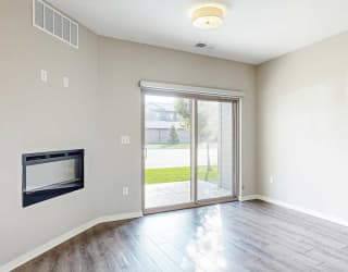 a living room with a fireplace and a sliding glass door