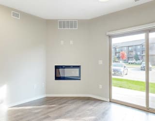 a living room with a fireplace and a sliding glass door