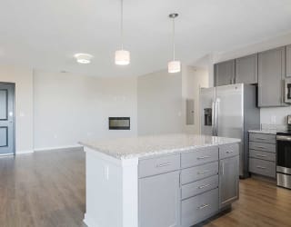 an open kitchen and living room with a large island