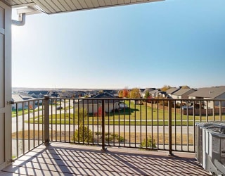 a balcony with a view of neighboring houses