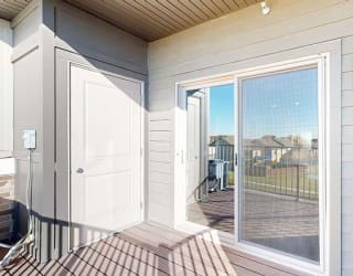 a balcony with outdoor storage and a sliding glass door