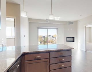 an open-concept living room and kitchen with peninsula countertop