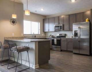 Large kitchen with stainless-steel appliances and peninsula at WH Flats new luxury apartments in south Lincoln NE 68516
