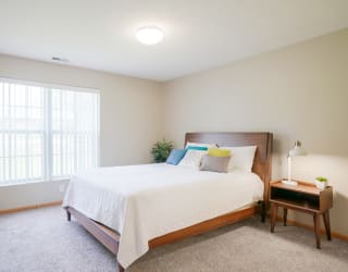 A furnished bedroom with a large bed and a window at Williamsburg Park
